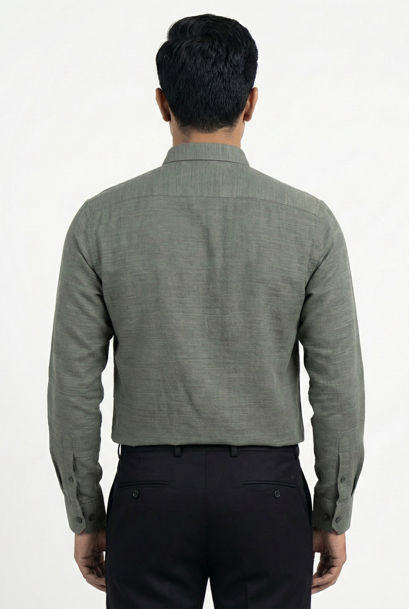 Man wearing a gray long-sleeve shirt and black pants on a white background