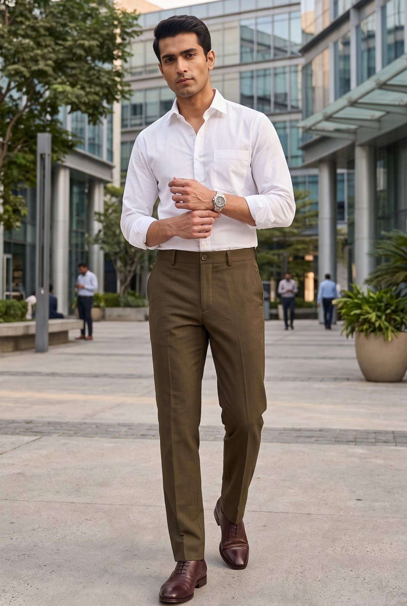 Brown slim-fit regular trousers on model with tapered legs and belt loops