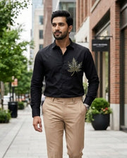 Black satin button-up shirt with long sleeves and chest embroidery