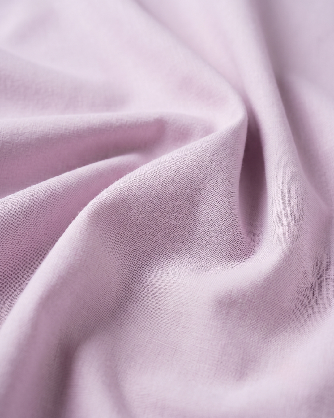 Light purple cotton fabric close-up with soft textured weave