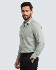 Light green cotton button-up shirt with chest pockets, front view, long sleeves