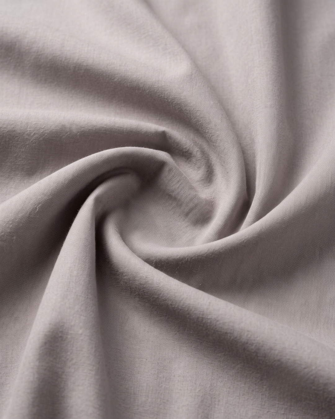 Light grey cotton fabric close-up with soft textured weave