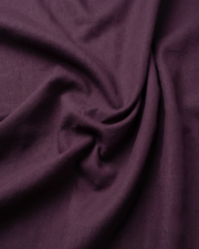 Dark purple cotton shirt fabric closeup, smooth weave and soft drape