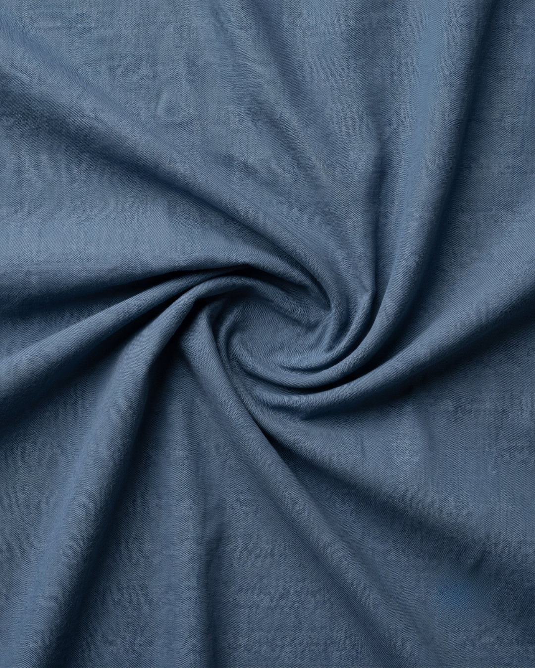 Dark grey cotton shirt fabric closeup, smooth weave with subtle texture