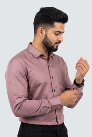 Dusty mauve button-up shirt with long sleeves and dark buttons, side view