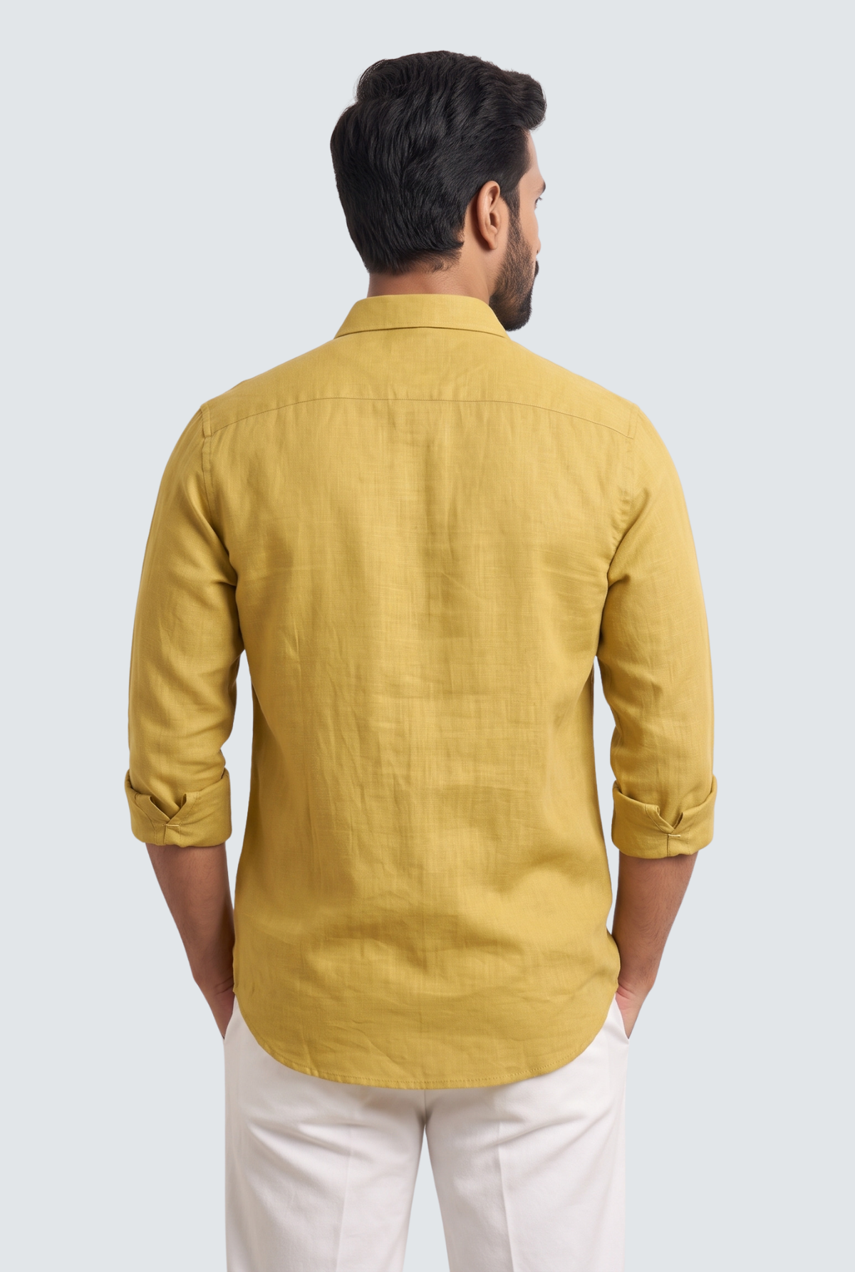 Back view of yellow linen button-up shirt with buttoned cuffs and yoke