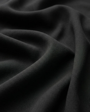 Black shirt fabric close-up with smooth, flowing drape