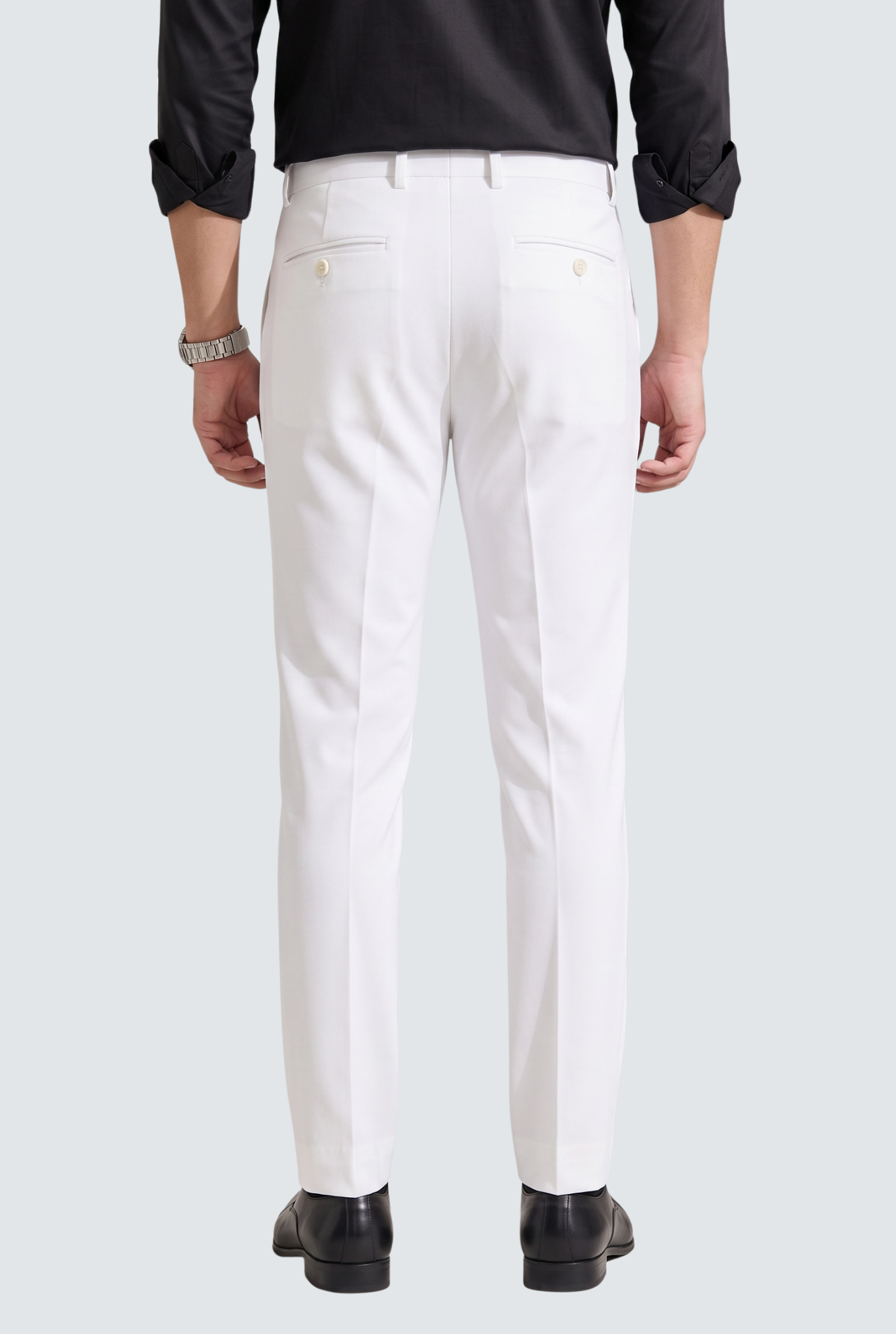 Men's white slim-fit trousers, back view with center seams and button pockets