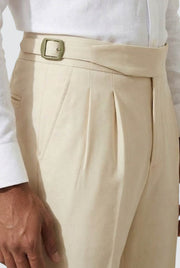Cream trousers detail: wide belt with square buckle and pleated front