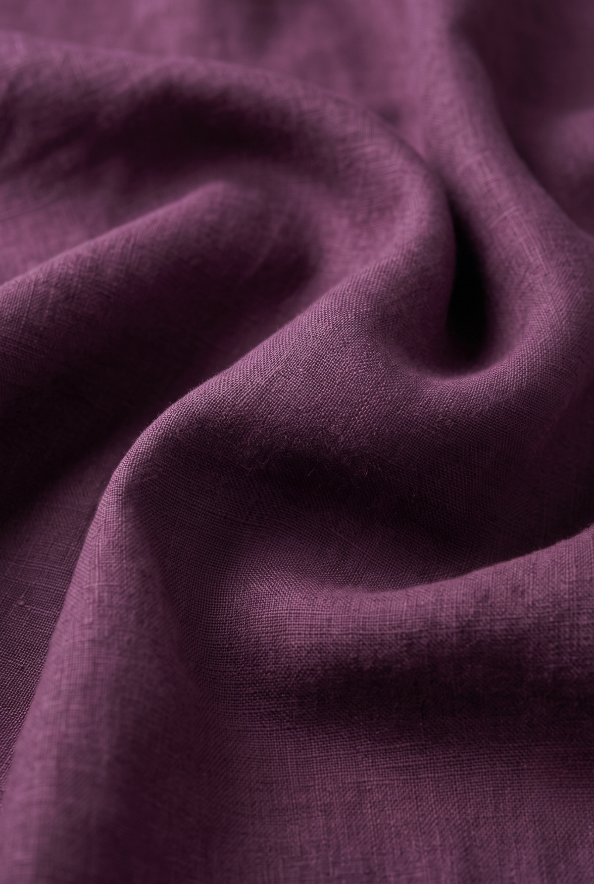 Wine-colored linen fabric close-up, textured weave