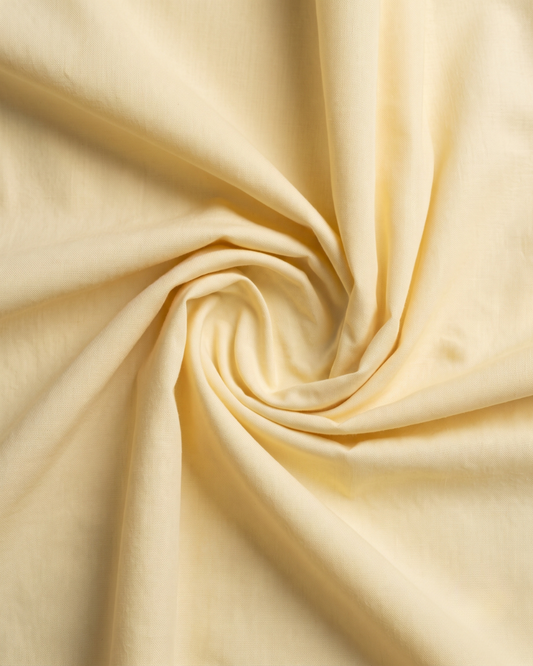 Lemon yellow cotton fabric close-up with soft wrinkle texture