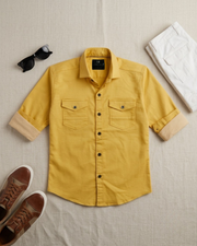 Folded boys yellow cotton short-sleeve button-up shirt with two chest pockets