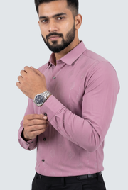 Pink button-up dress shirt with dotted pattern and spread collar, worn with dark trousers