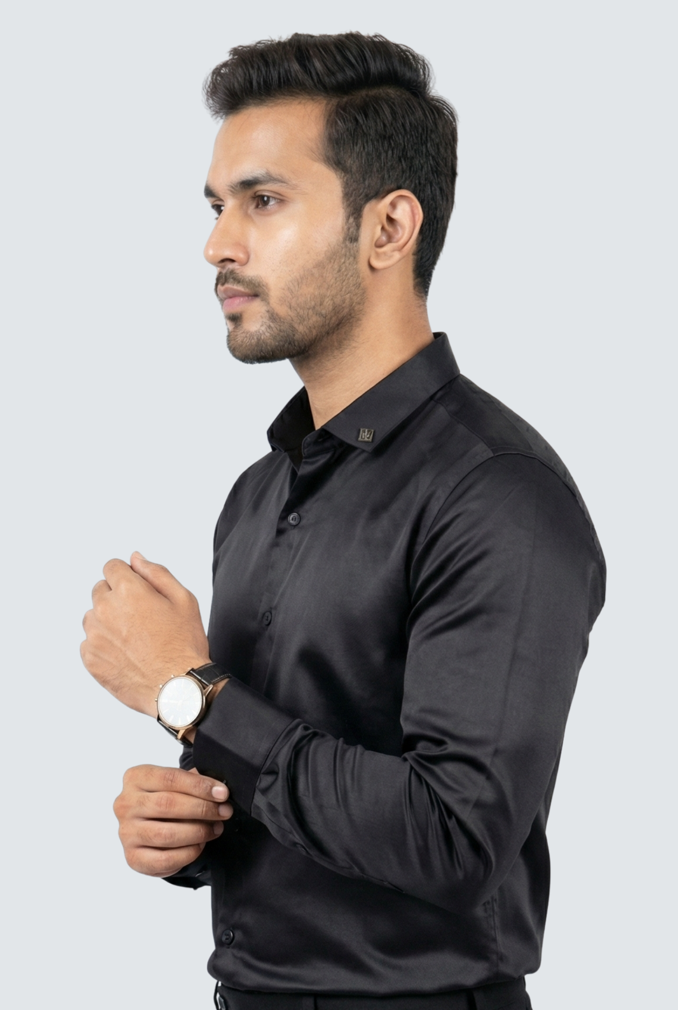 Man wearing a black shirt against a light gray background