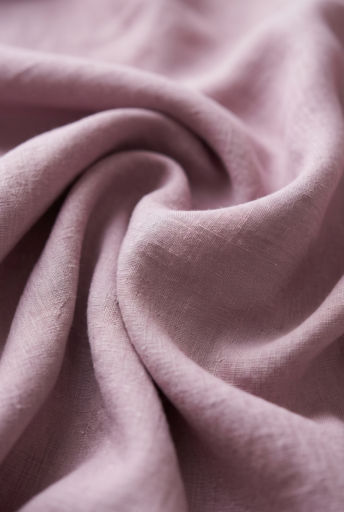 Light purple linen fabric close-up with soft weave texture and natural folds