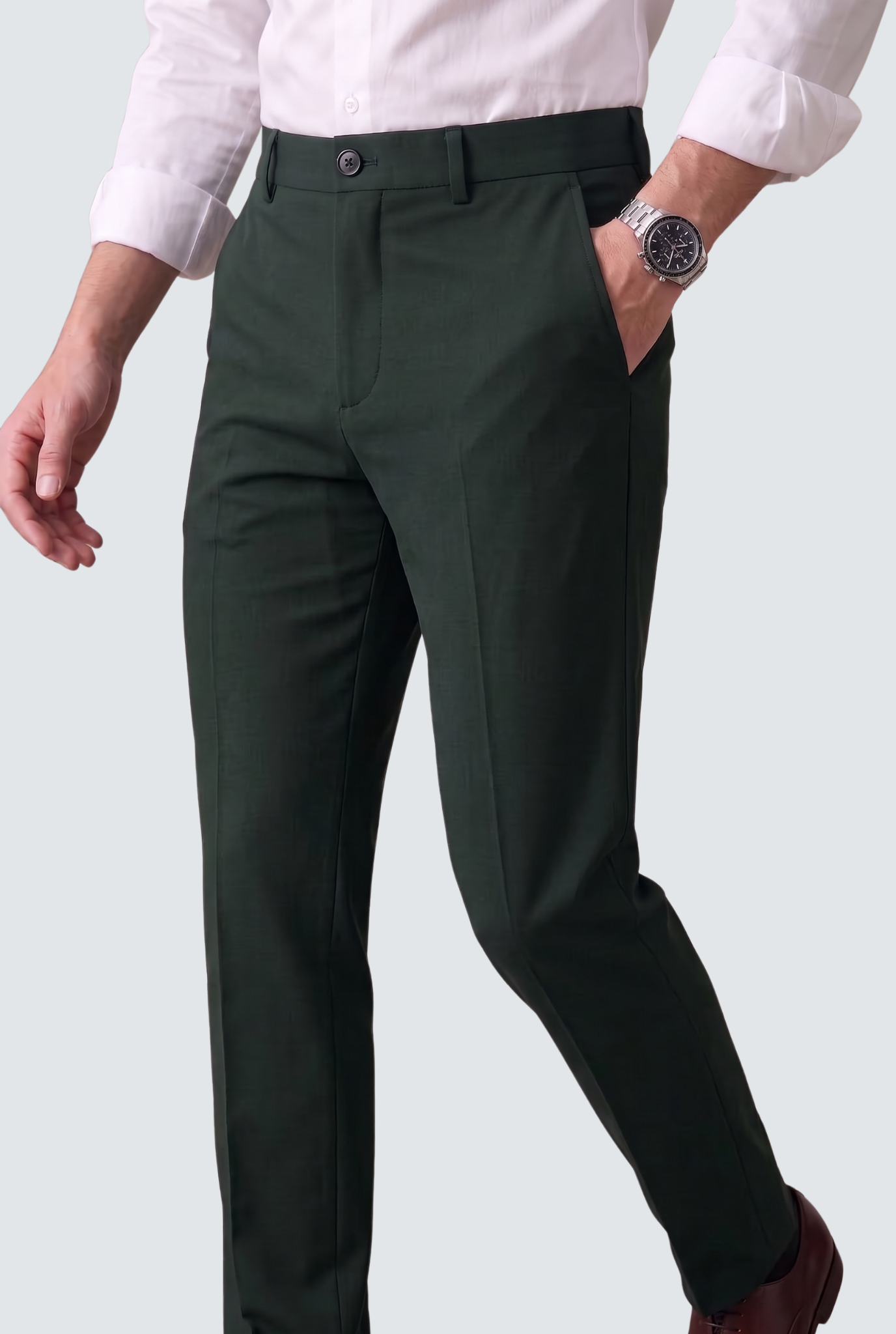 Bottle green slim-fit regular trousers with button closure, belt loops, and front creases.