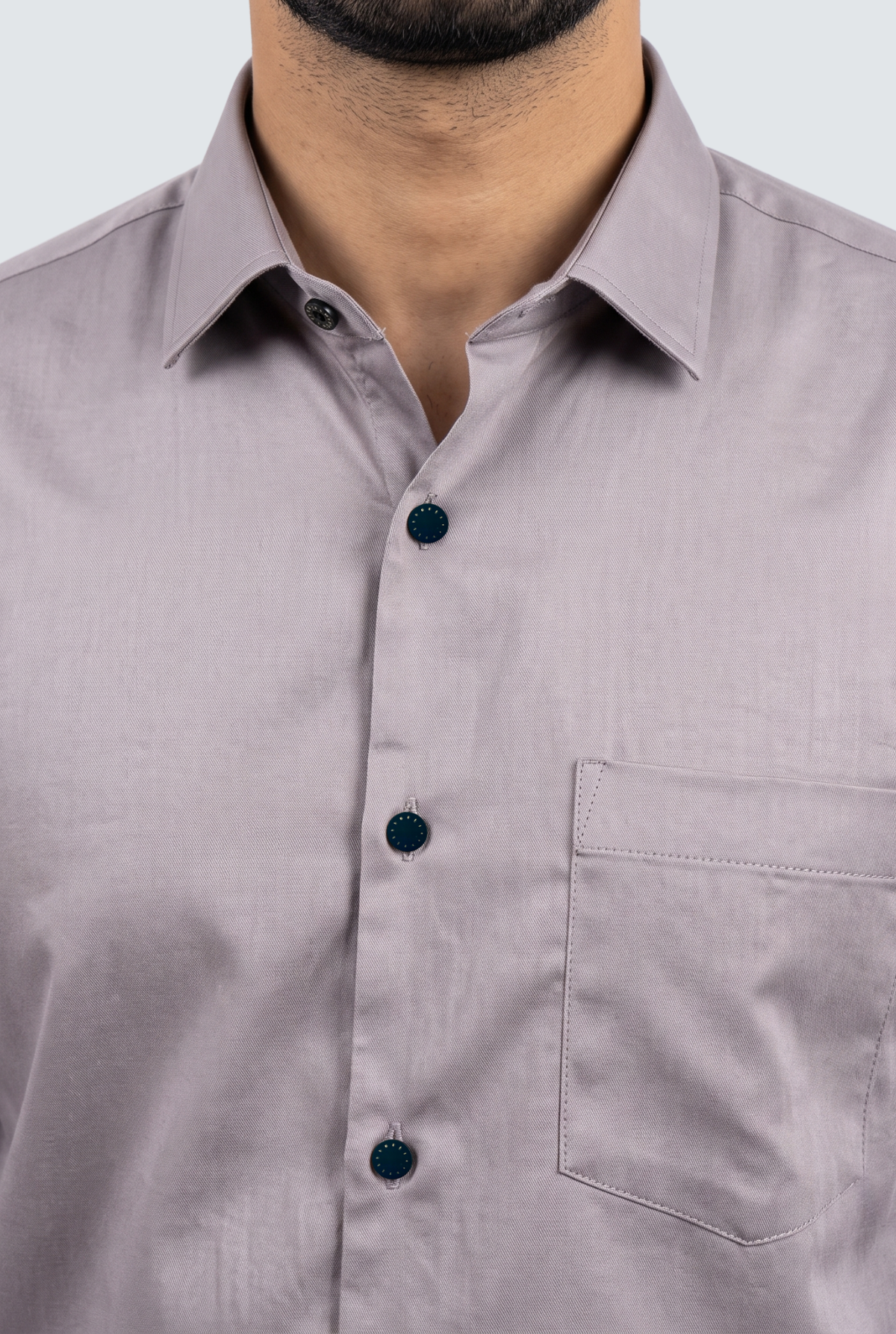 Light grey dress shirt close-up: spread collar, dark button placket, chest pocket