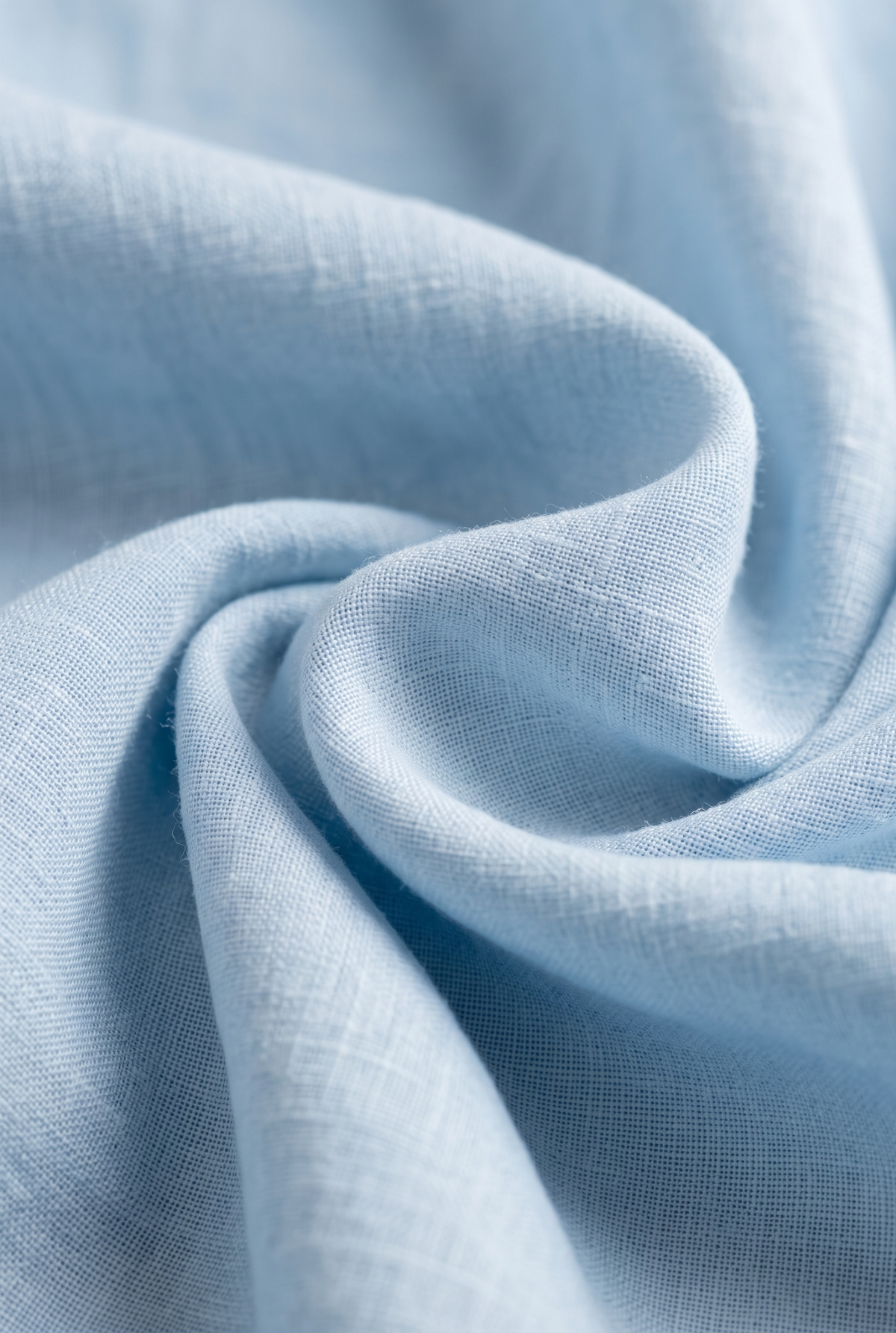 Light sky blue linen fabric close-up, textured weave