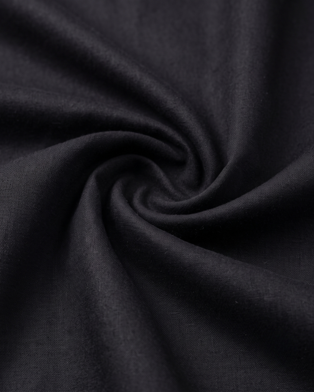 Black cotton shirt fabric close-up, smooth weave
