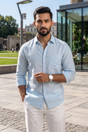 Sky blue linen button-up shirt with chest pocket, front view on model