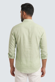 Light green linen button-up shirt, back view, long sleeves and curved hem