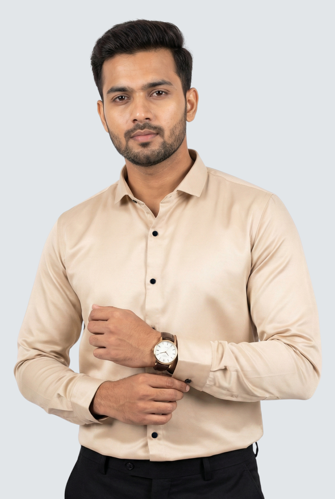 Man wearing a beige shirt with black buttons on a light gray background