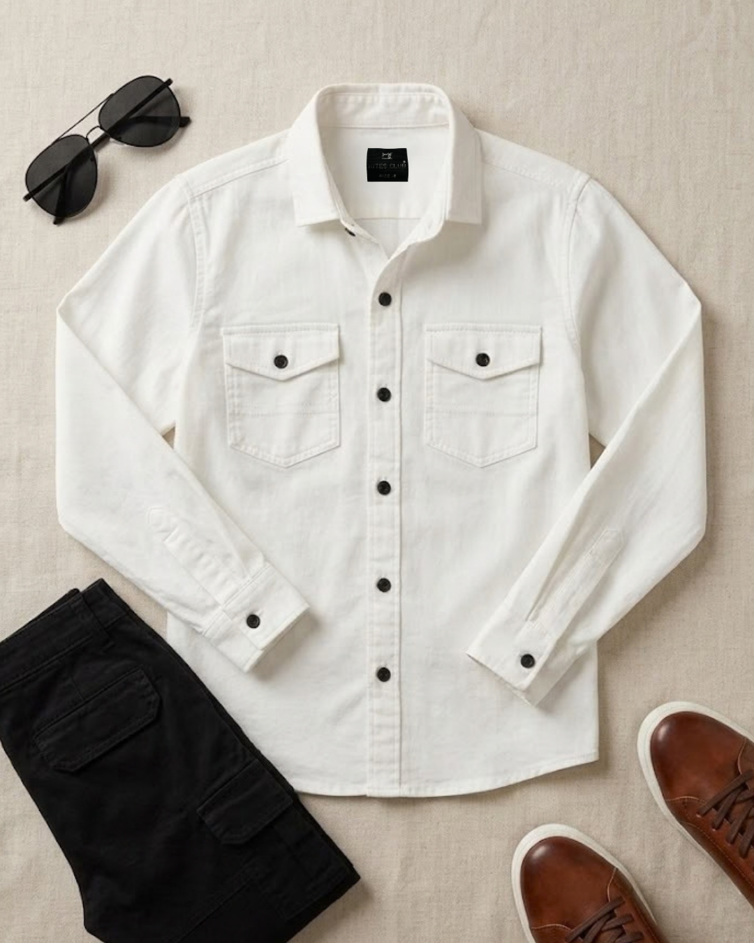 Boys white cotton button-up shirt with two chest flap pockets and black buttons