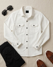 Boys white cotton button-up shirt with two chest flap pockets and black buttons