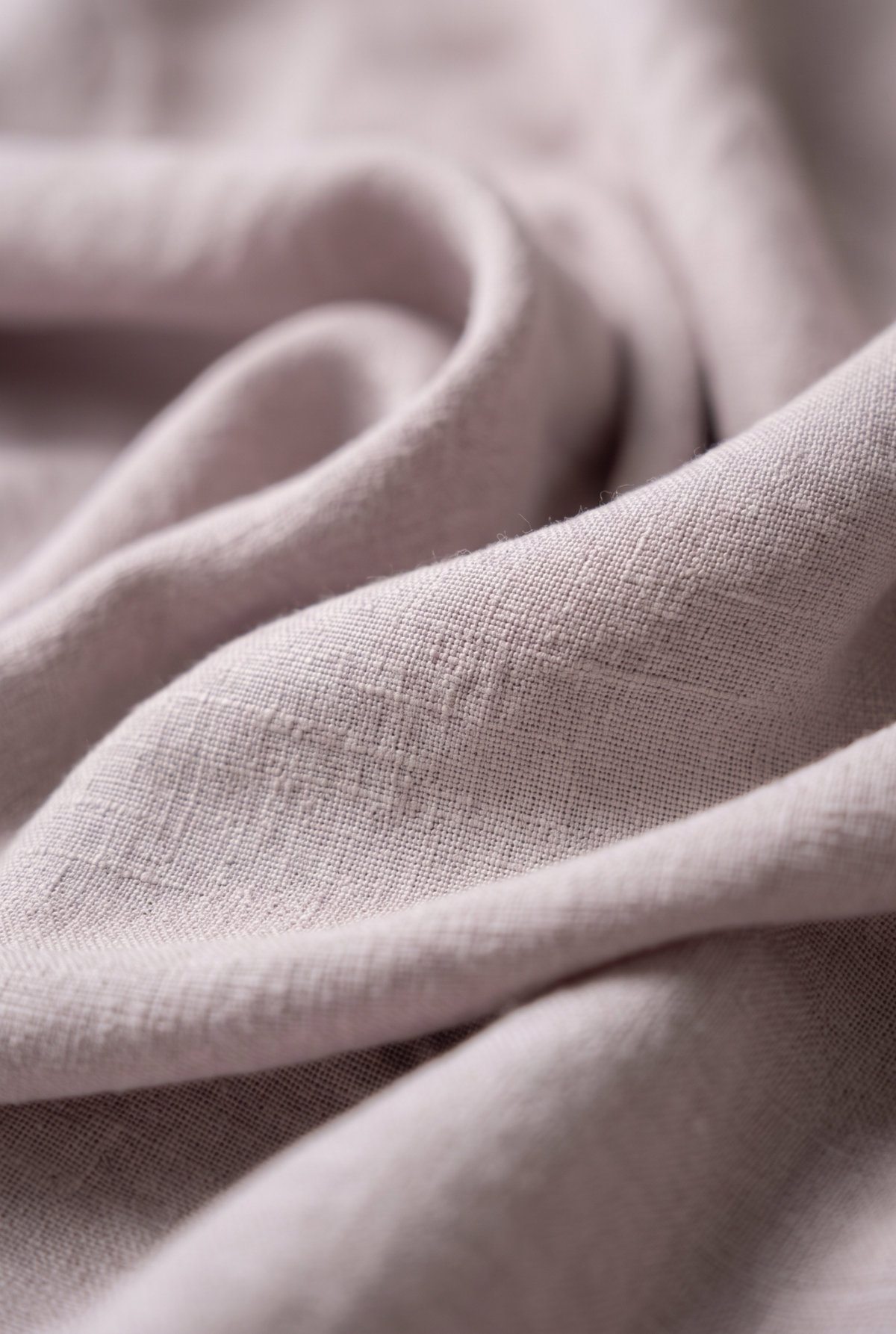Light gray linen fabric close-up with textured weave