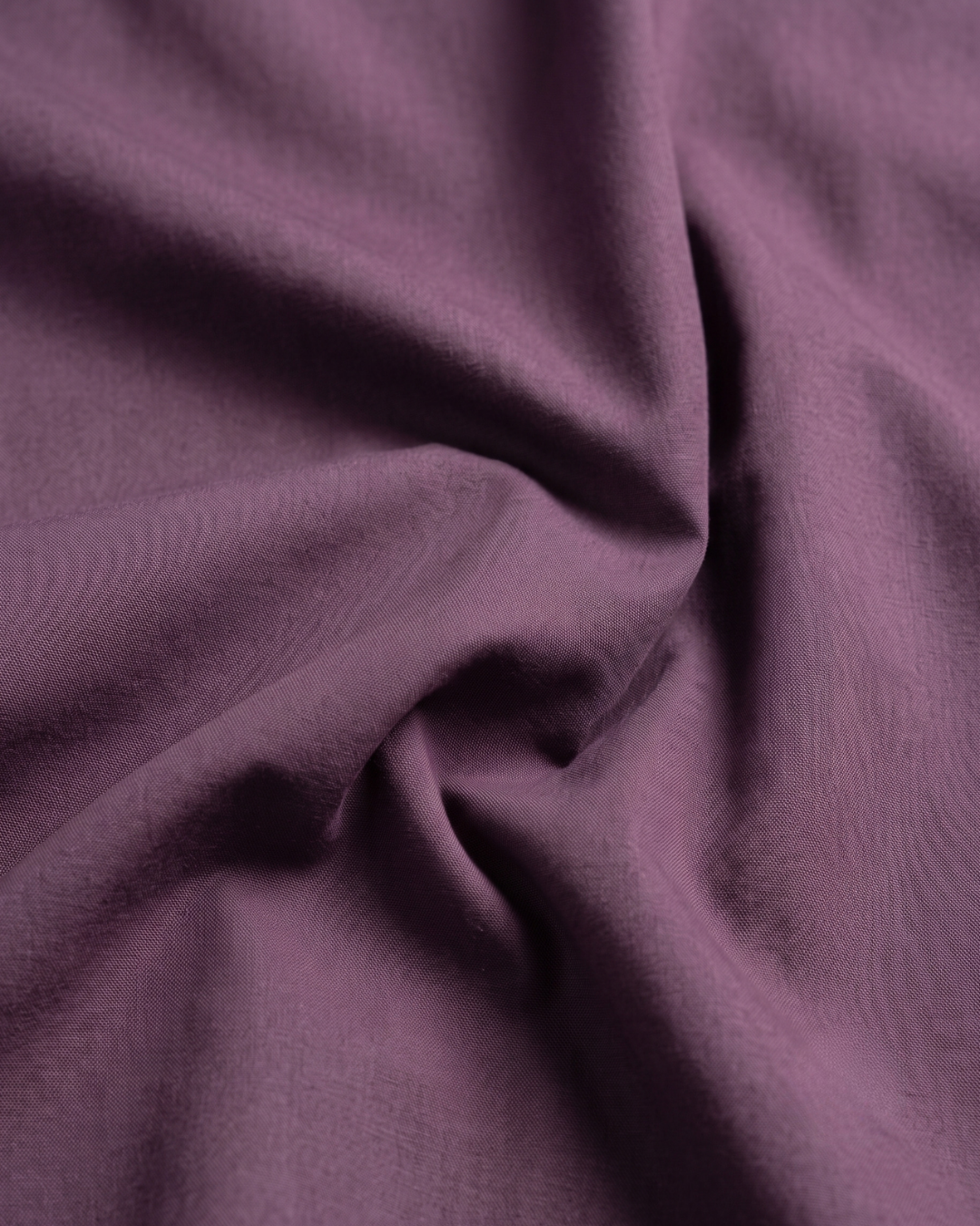 Lavender cotton shirt fabric, draped close-up with smooth weave