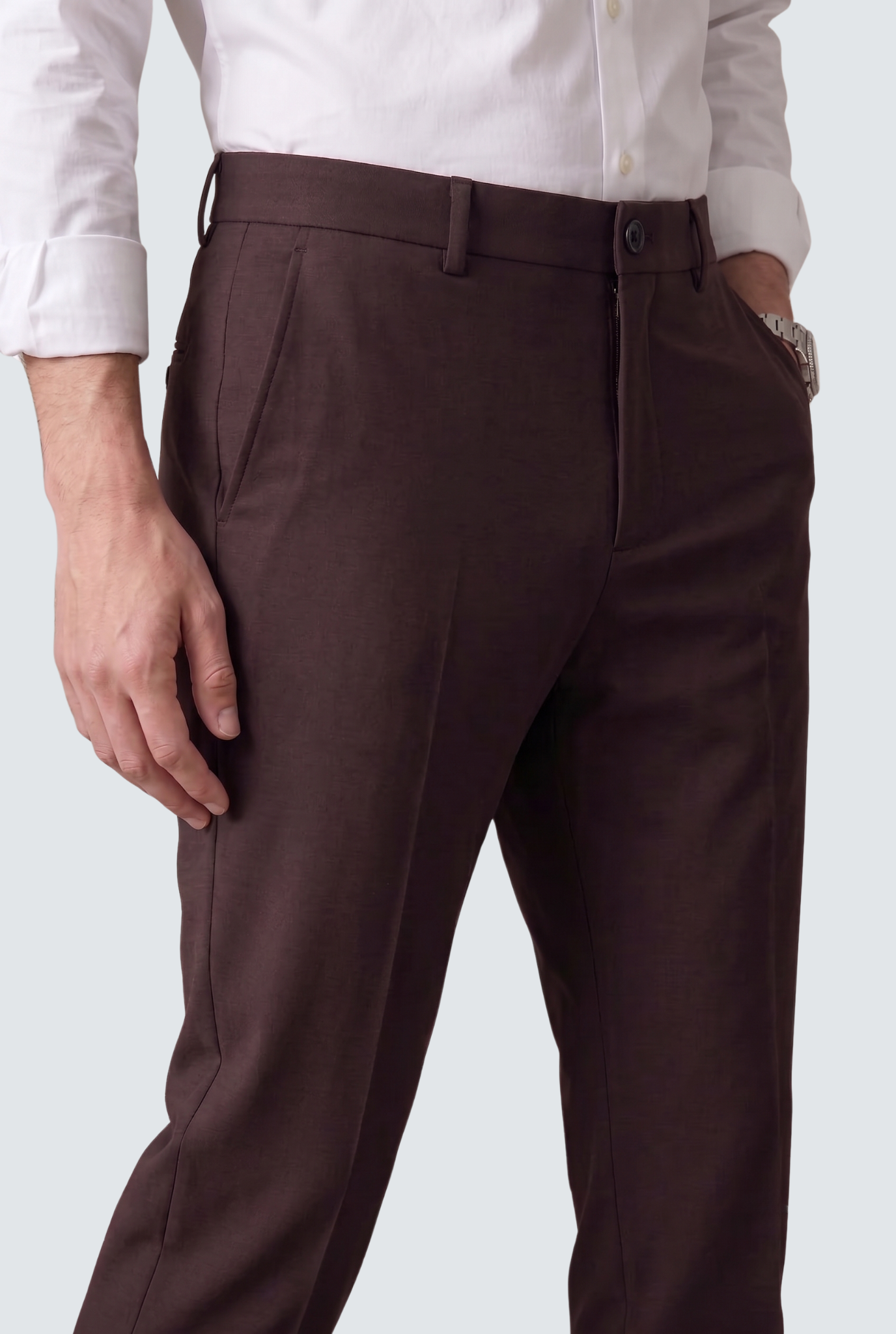 Men's dark purple slim-fit trousers close-up of button waistband and front seam