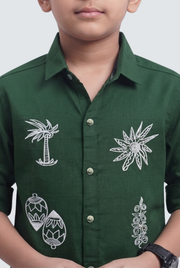 Boys green twill cotton shirt close-up with white chest motifs and button placket