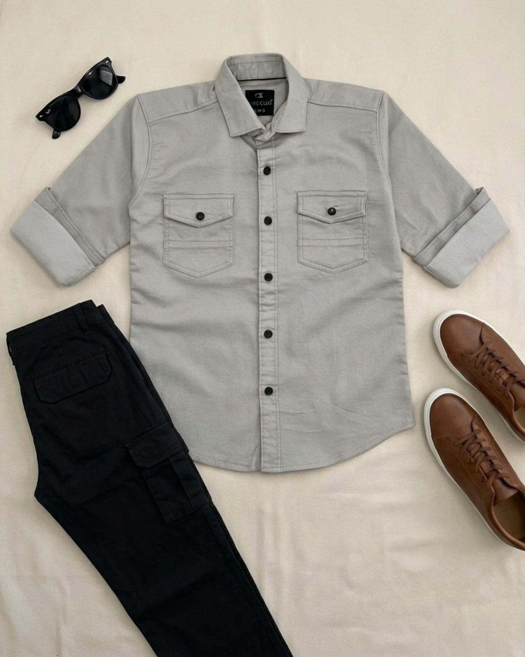 Grey cotton button-up shirt with two chest pockets, laid flat