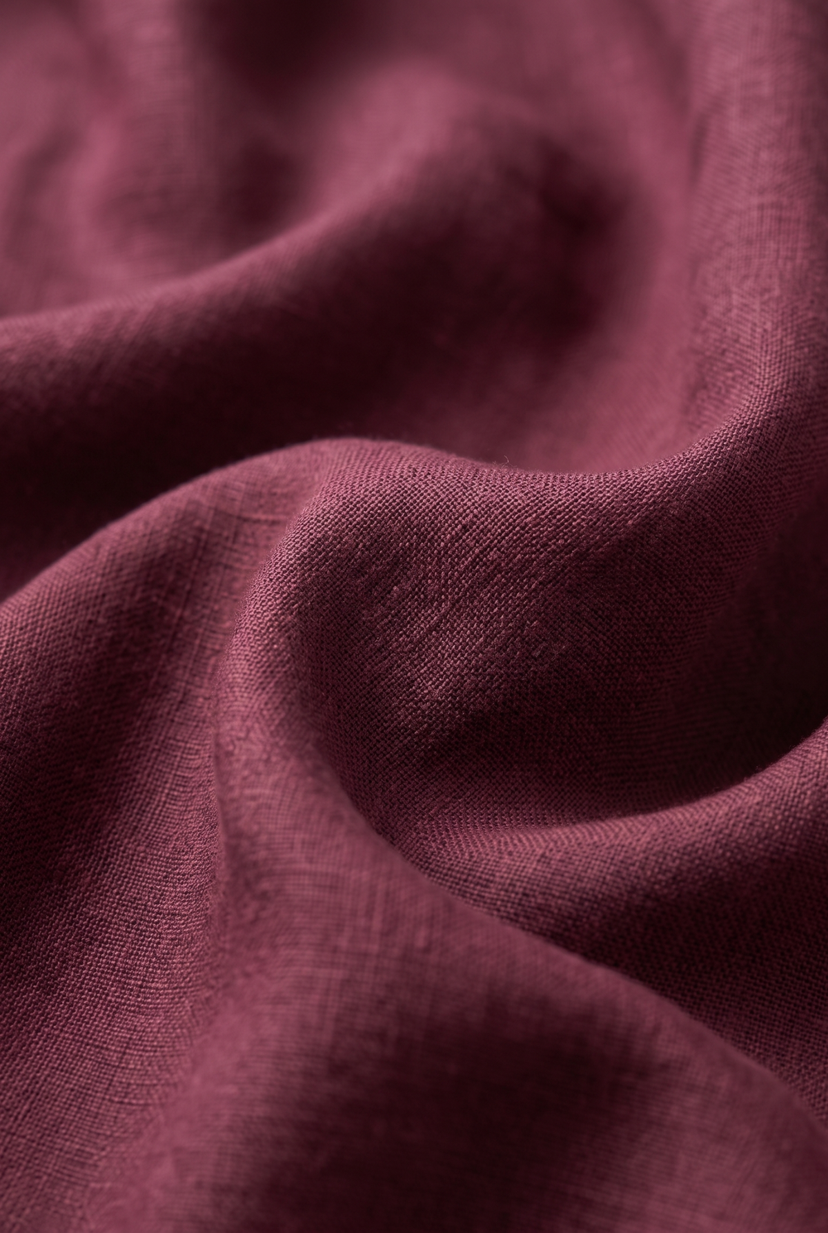 Maroon linen fabric close-up with visible woven texture