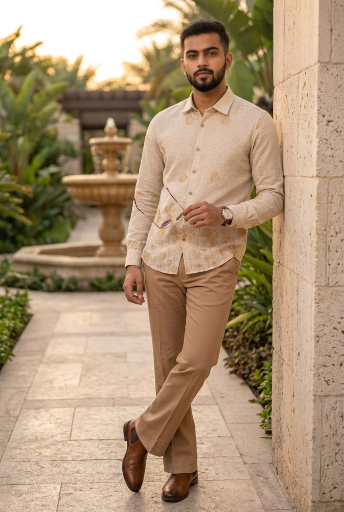 Cream linen button-up shirt with leaf print, long sleeves, and pointed collar.