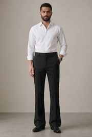 Black bootcut trousers on model with straight thigh and flared hem