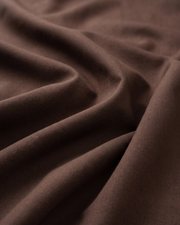 Brown cotton fabric close-up, smooth weave with subtle sheen
