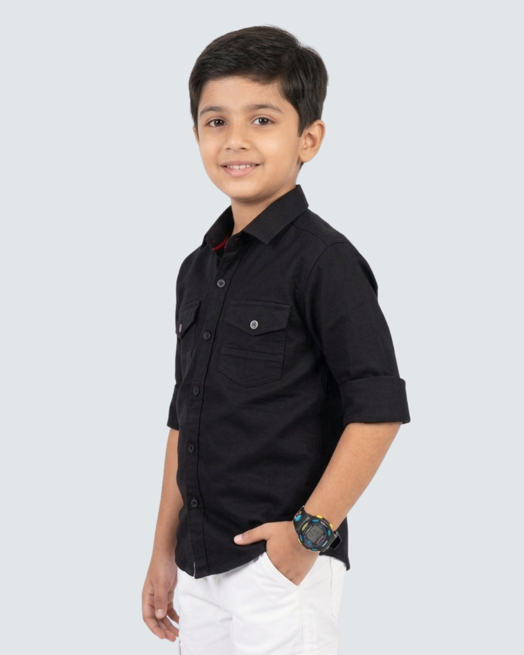 Boys black cotton button-up shirt with chest pockets, side view