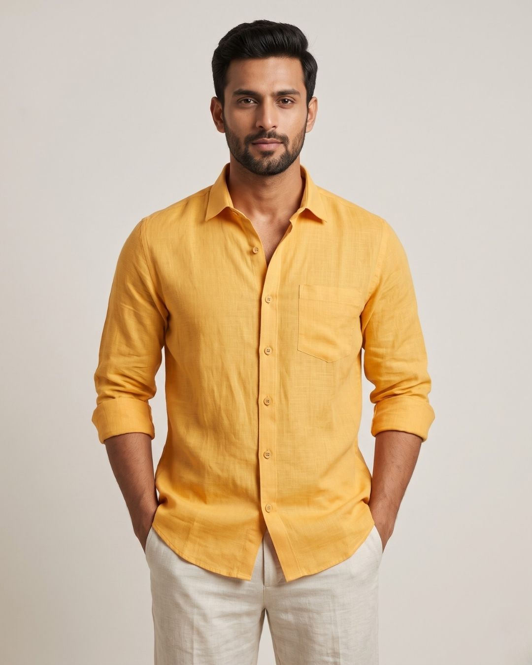 Front view of a yellow linen shirt with a chest pocket and rolled sleeves