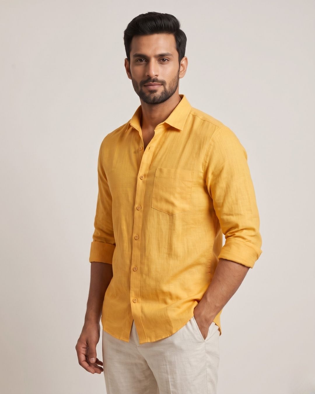 Yellow linen shirt with a chest pocket, button front, and rolled sleeves