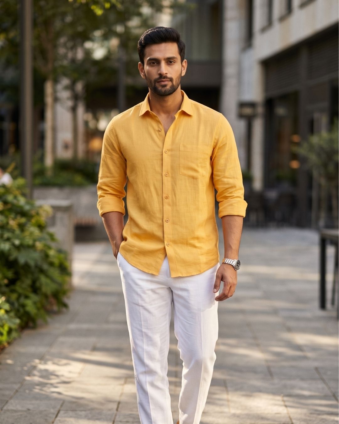 Yellow linen shirt with a chest pocket and rolled sleeves, worn with light trousers