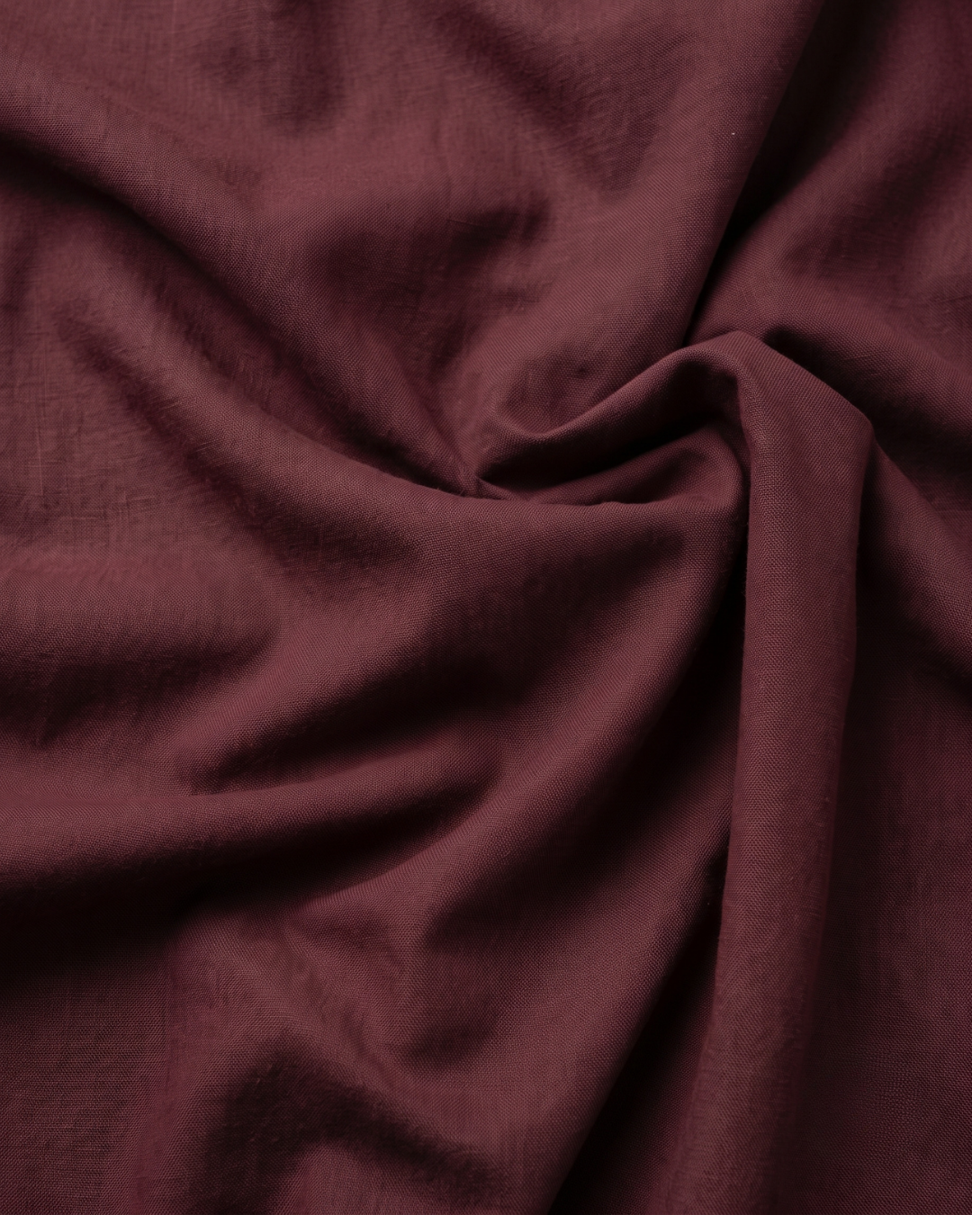 Maroon cotton fabric close-up with soft textured weave