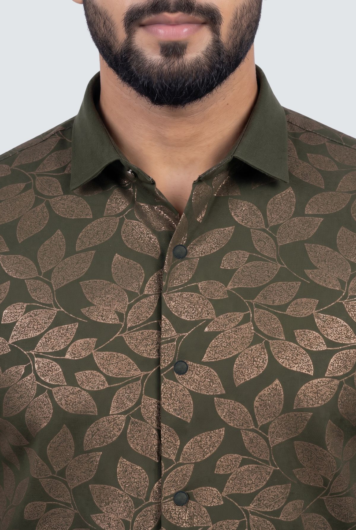 Men's dress shirt front close-up, brown leaf pattern on dark green, 3 buttons