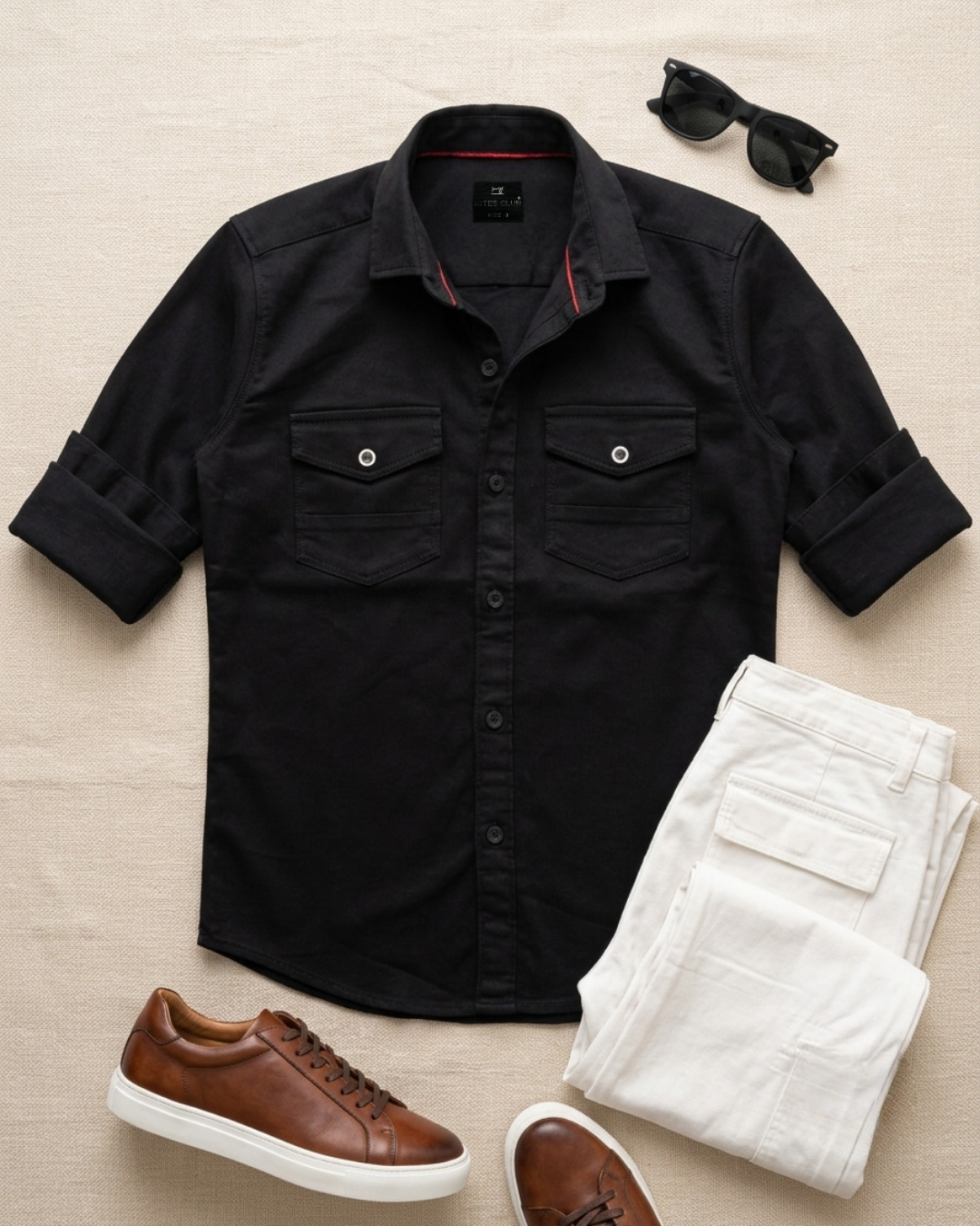 Black cotton button-up shirt with chest pockets and rolled cuffs