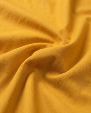 Close-up of yellow cotton fabric with soft woven texture