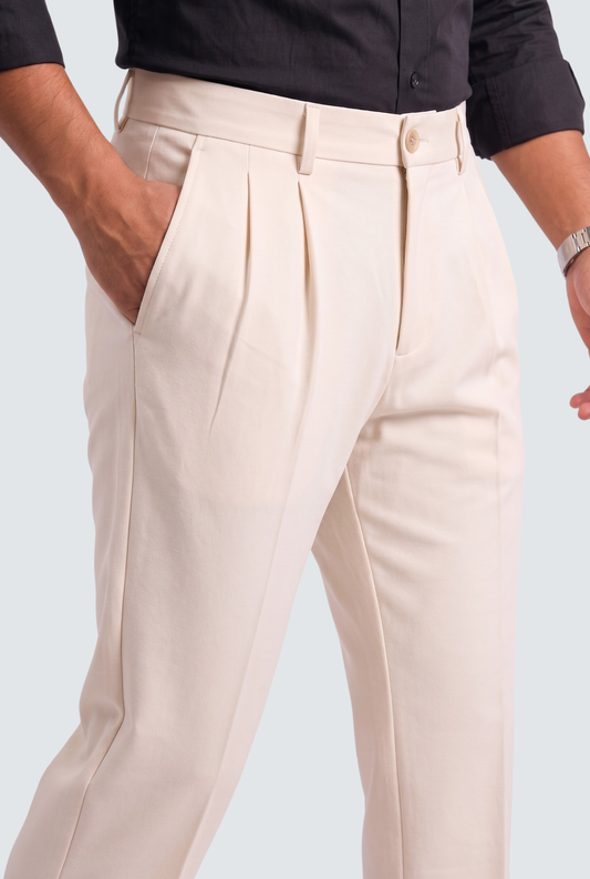 Men's cream gurkha trousers close-up, pleated front and waist adjustment tabs