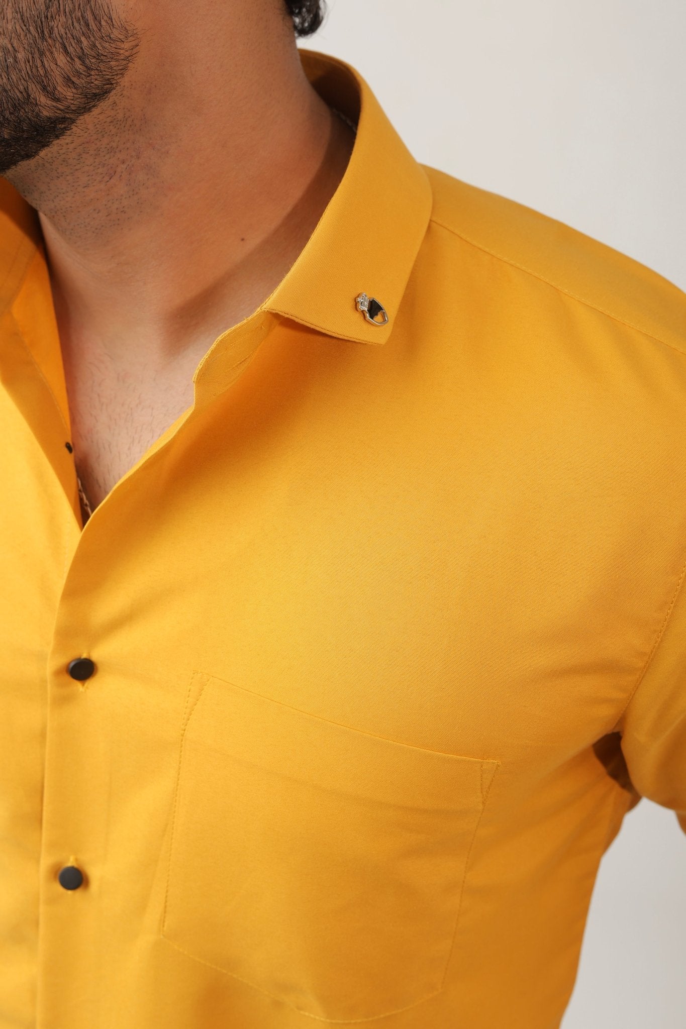 Close-up of mustard shirt fabric – soft cotton texture