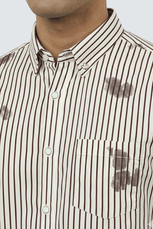“Close-up of cream striped printed shirt showing collar and print details”