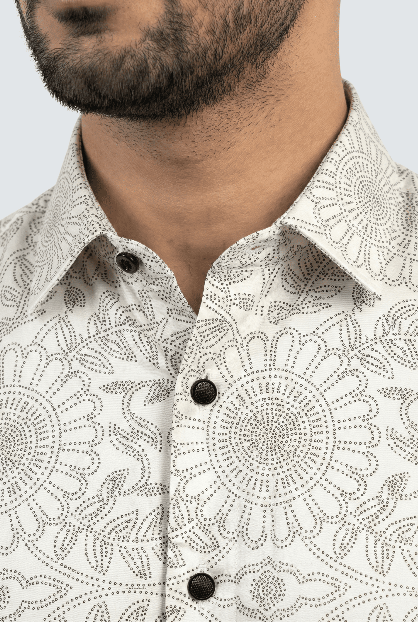 Close-up of white cotton dobby fabric with elegant brown print detailing