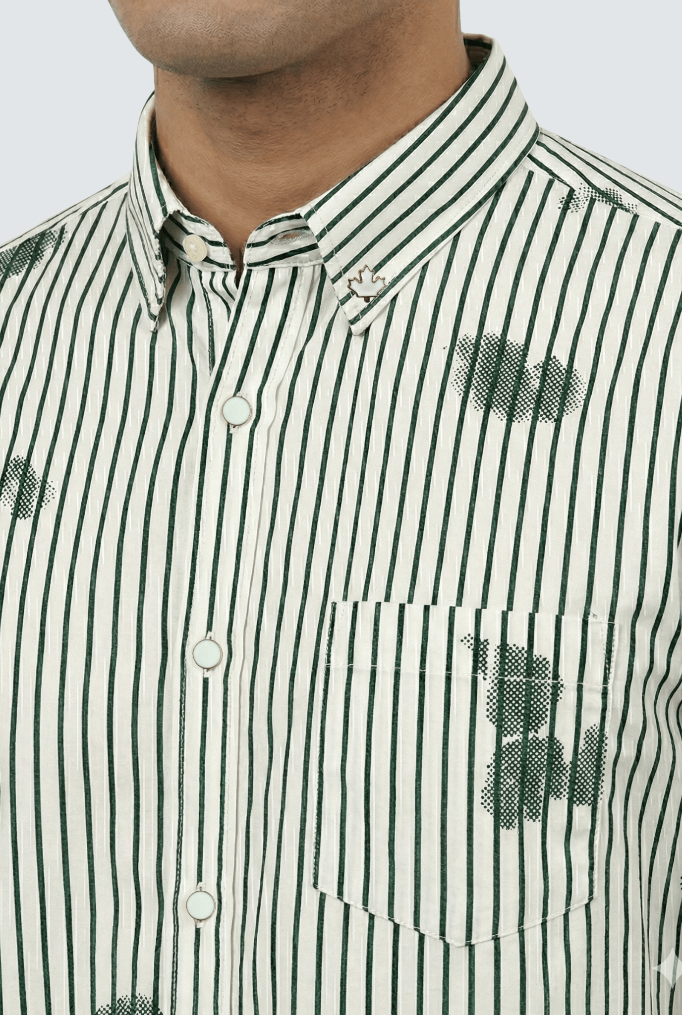 “Close-up of white and green striped printed shirt showing fabric and collar details”